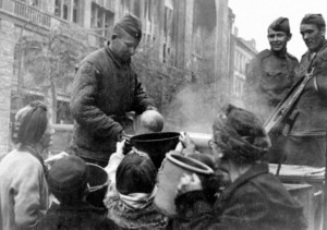 Soviet soldiers ladling out soup to hungry Berliners, May 1945